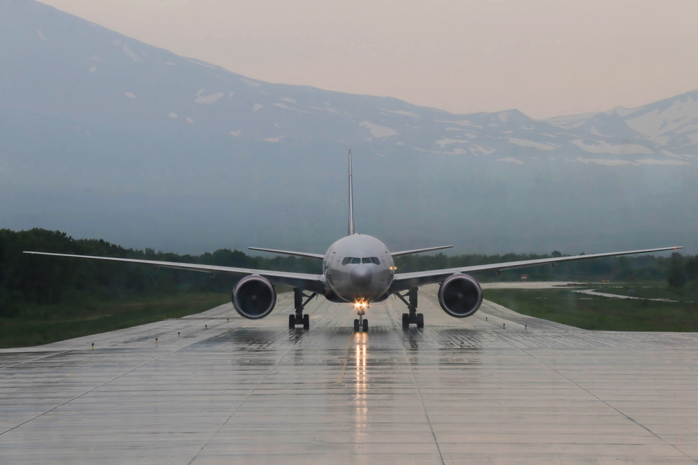 airplane on wet runway taxiing